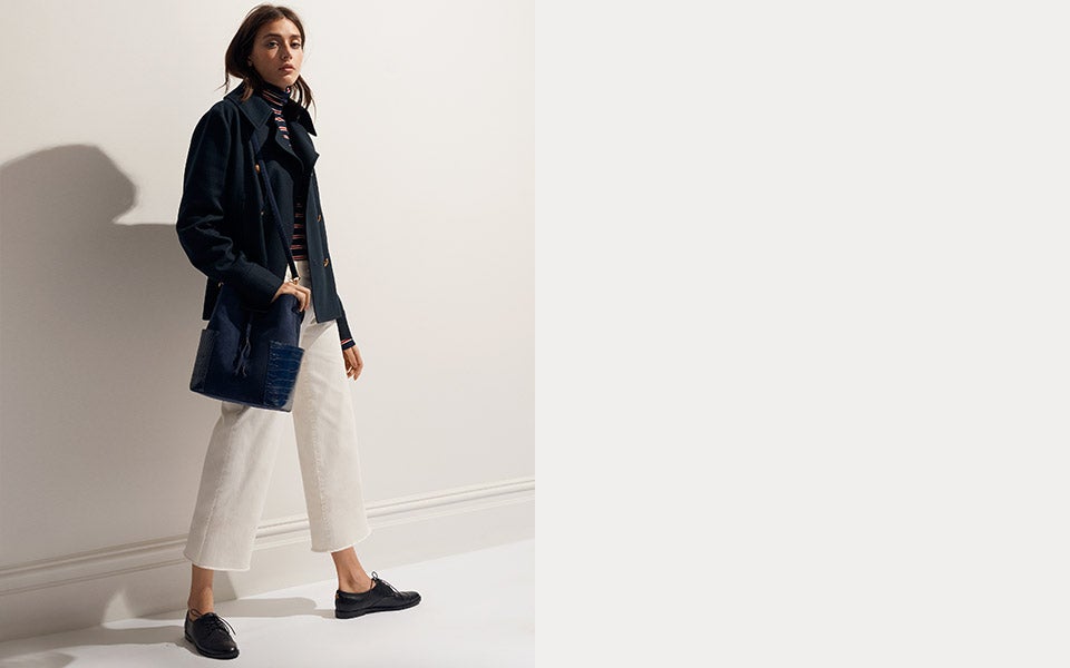 Model in navy blazer with white stripes