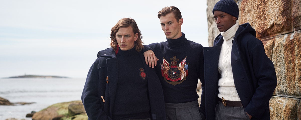 Models wear cold weather outfits in navy, grey, and white.