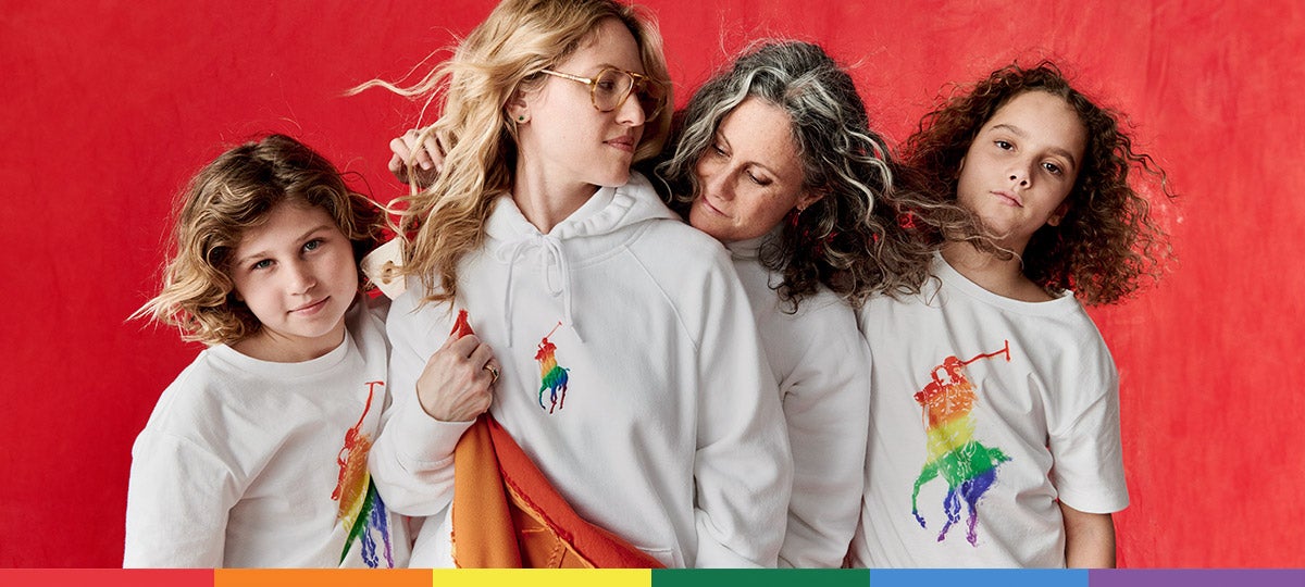 Women and children wear white tees and sweatshirts with rainbow ponies at the chest.