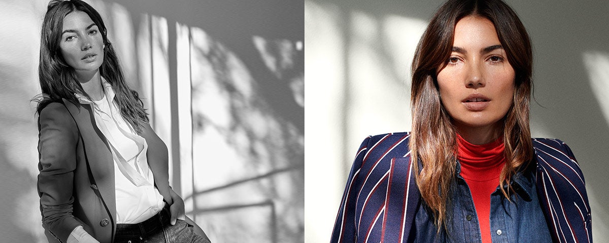 Model wears blazer over button-down shirt.